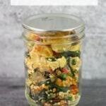 Mason jar filled with a blend of dried vegetables for soup.