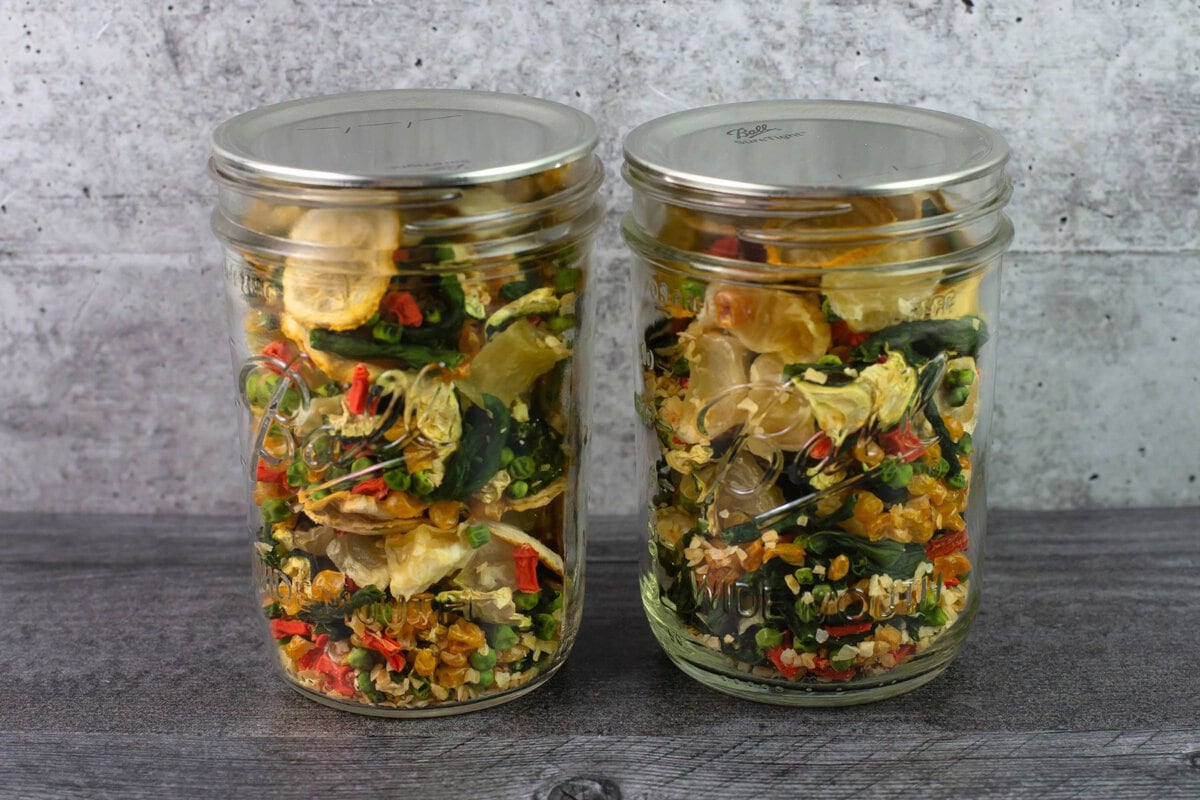 Two pint mason jars filled with dry soup mix.