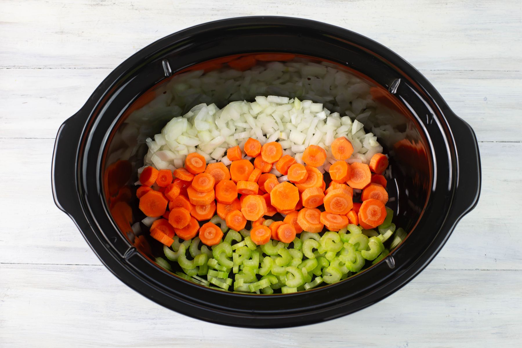 Precut carrots, onions, and celery in a 8 quart crock pot.