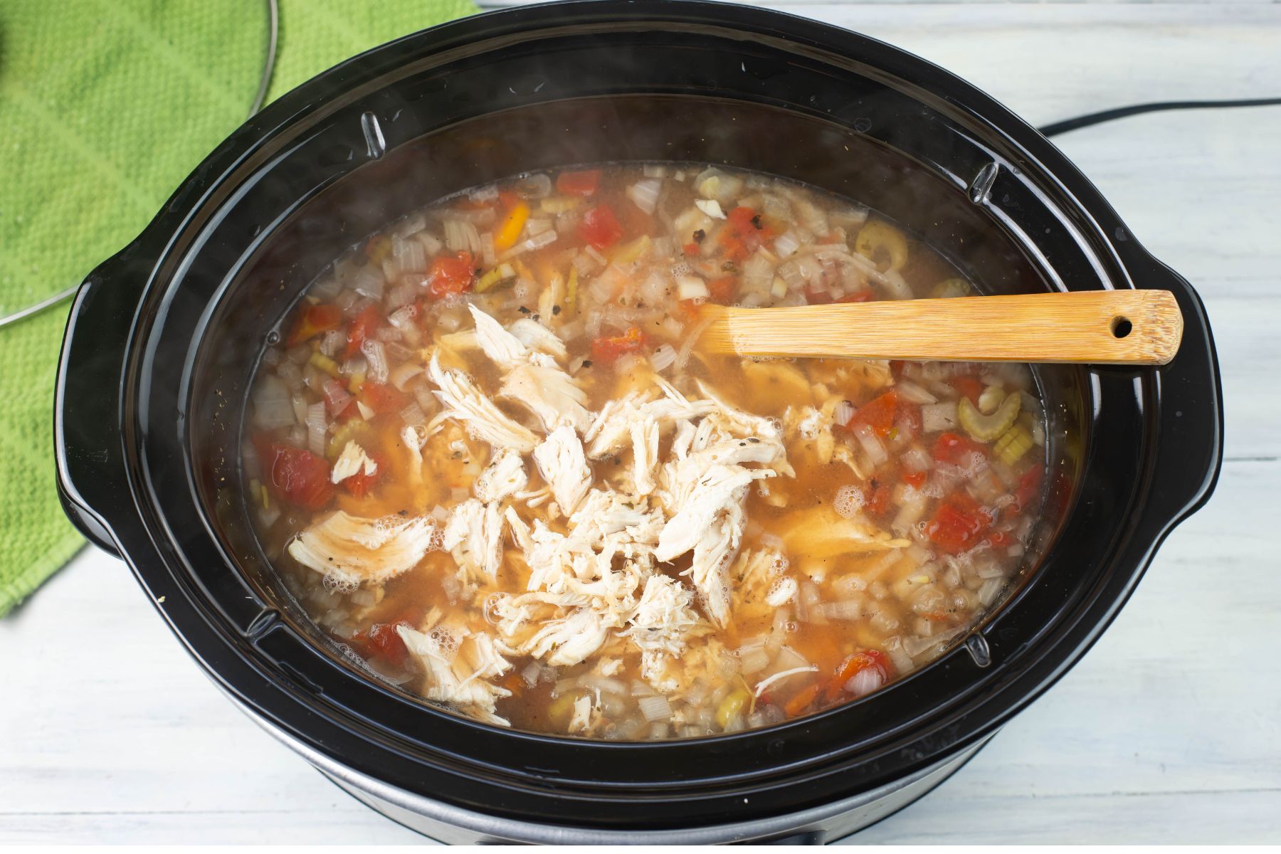 Shredded chicken added to the crock pot Tuscan soup.