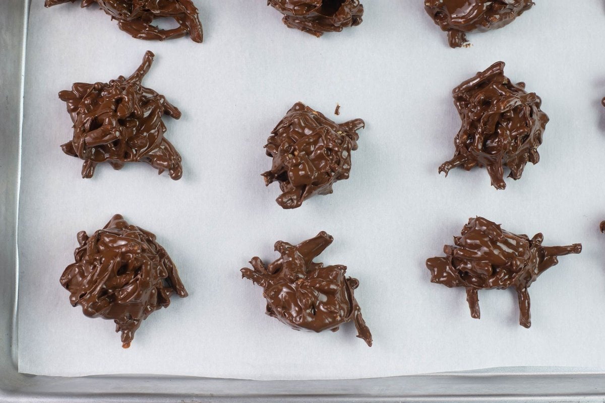 Scooped cookies on a lined baking sheet.