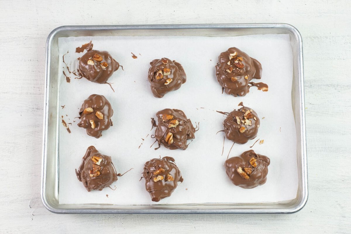 Chocolate  dipped candy hardening on a cookie sheet.