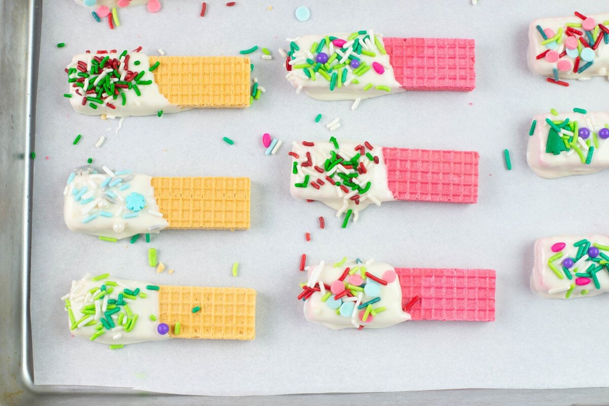 Vanilla and pink strawberry wafer cookies decorated for Christmas.