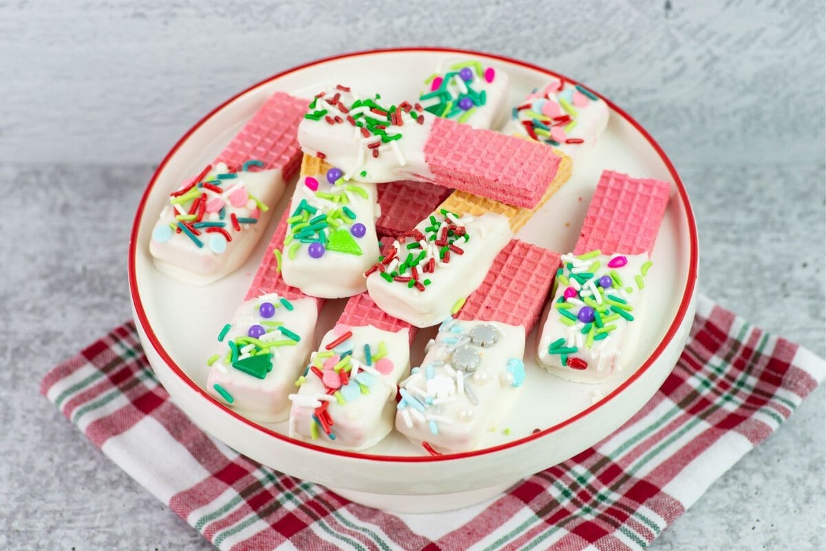 Pink no bake Christmas vanilla wafer cookies on a cake stand.