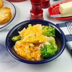 Chicken and broccoli casserole with rice in a blue bowl.