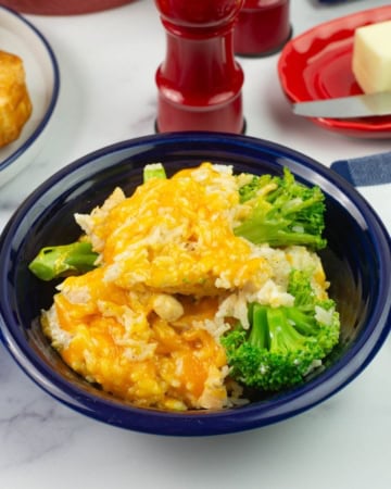 Chicken and broccoli casserole with rice in a blue bowl.