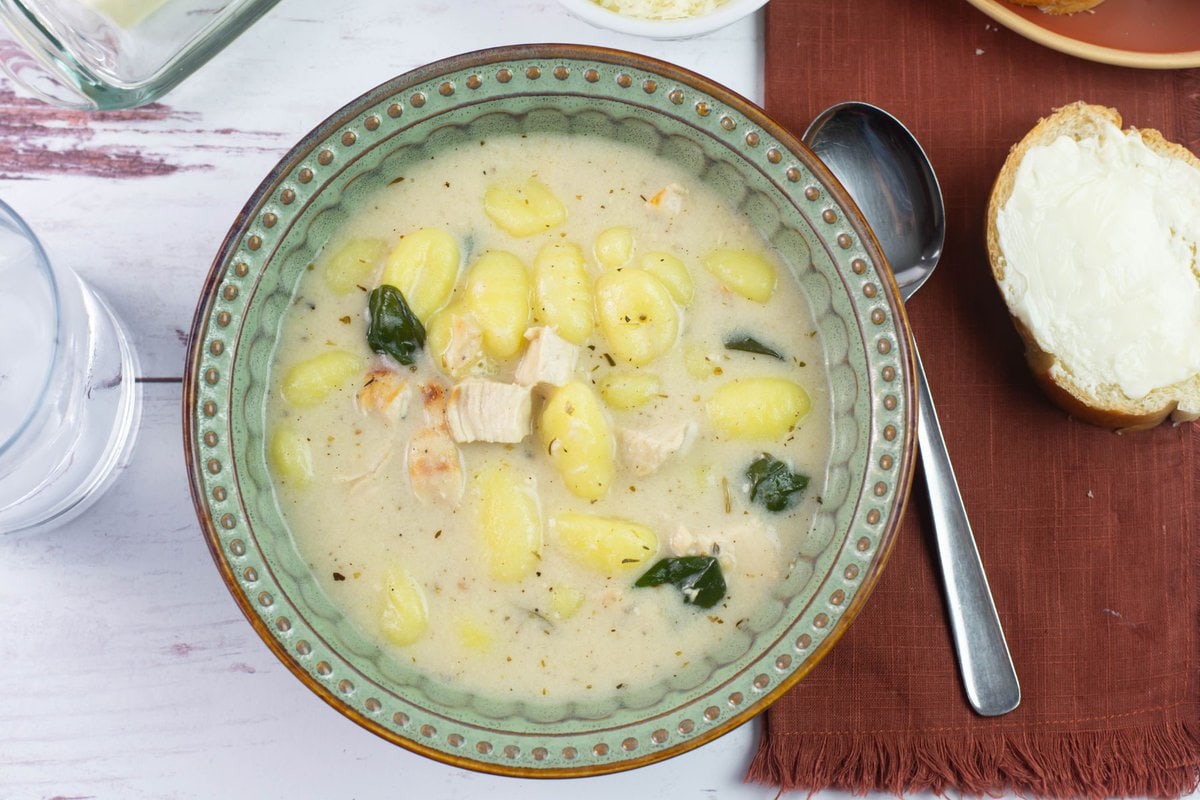 Potato dumpling soup in a bowl on a table.