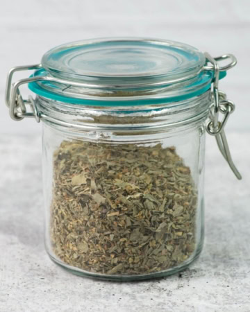 Large airtight glass spice jar filled with season blend.
