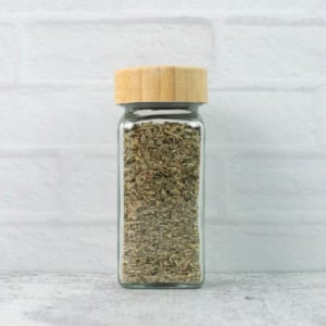 Homemade Italian Seasoning in a glass spice jar.