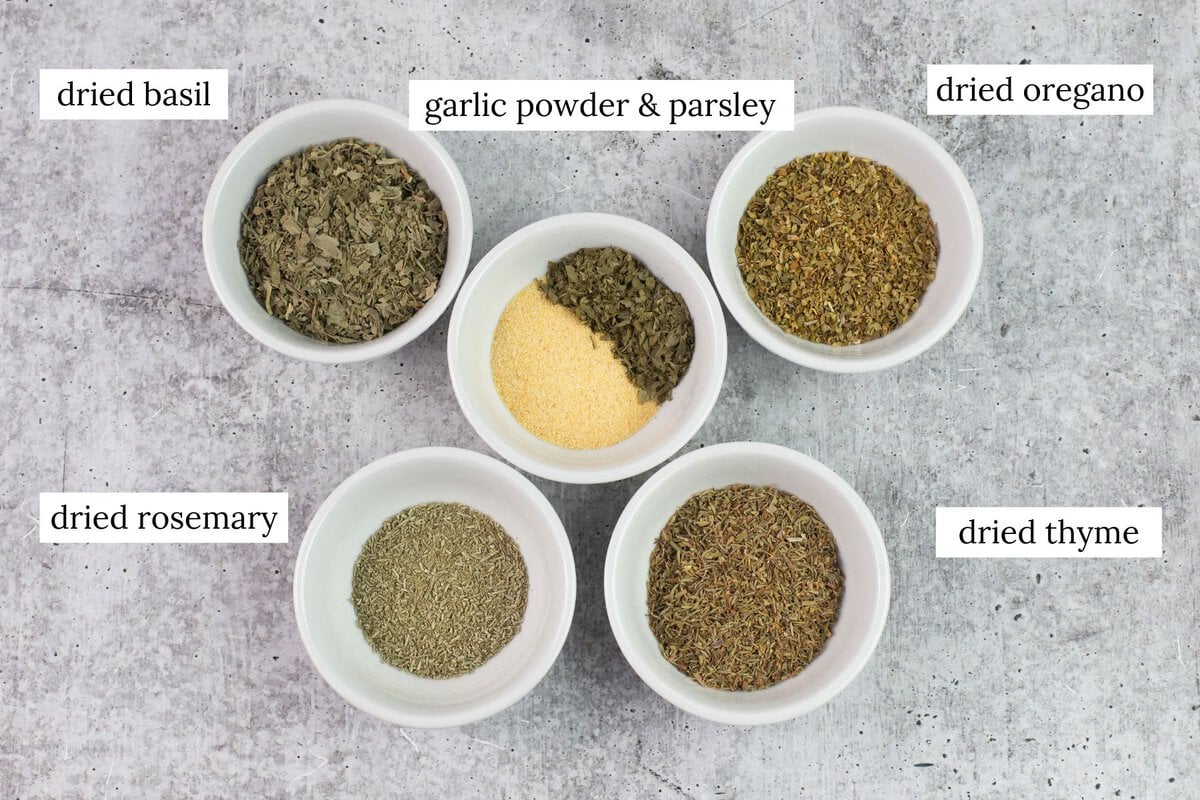 Dried Italian Seasoning herbs in small bowls.