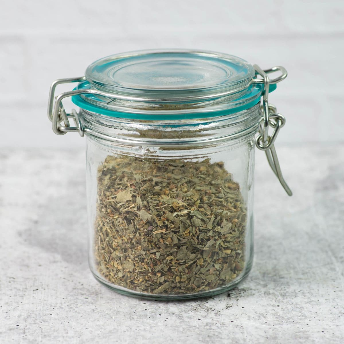 Large airtight glass spice jar filled with season blend.