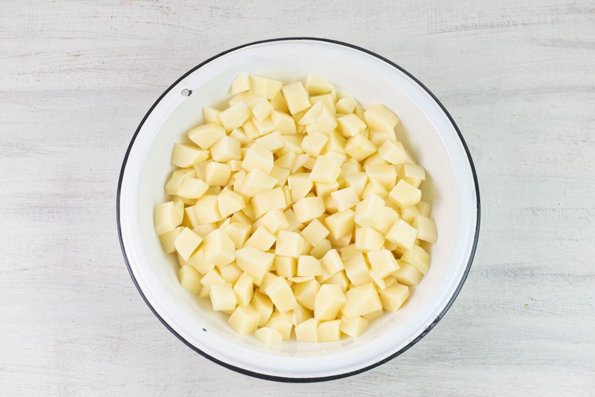 Raw cubed potatoes in a bowl.