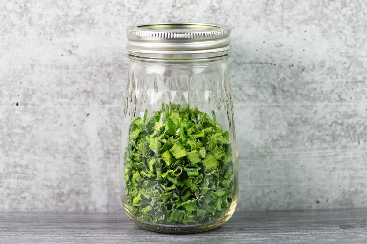 Dried green onion tops in jar.