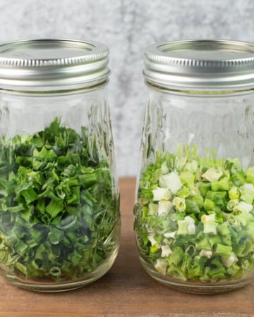 Dried green onions in 2 mason jars.