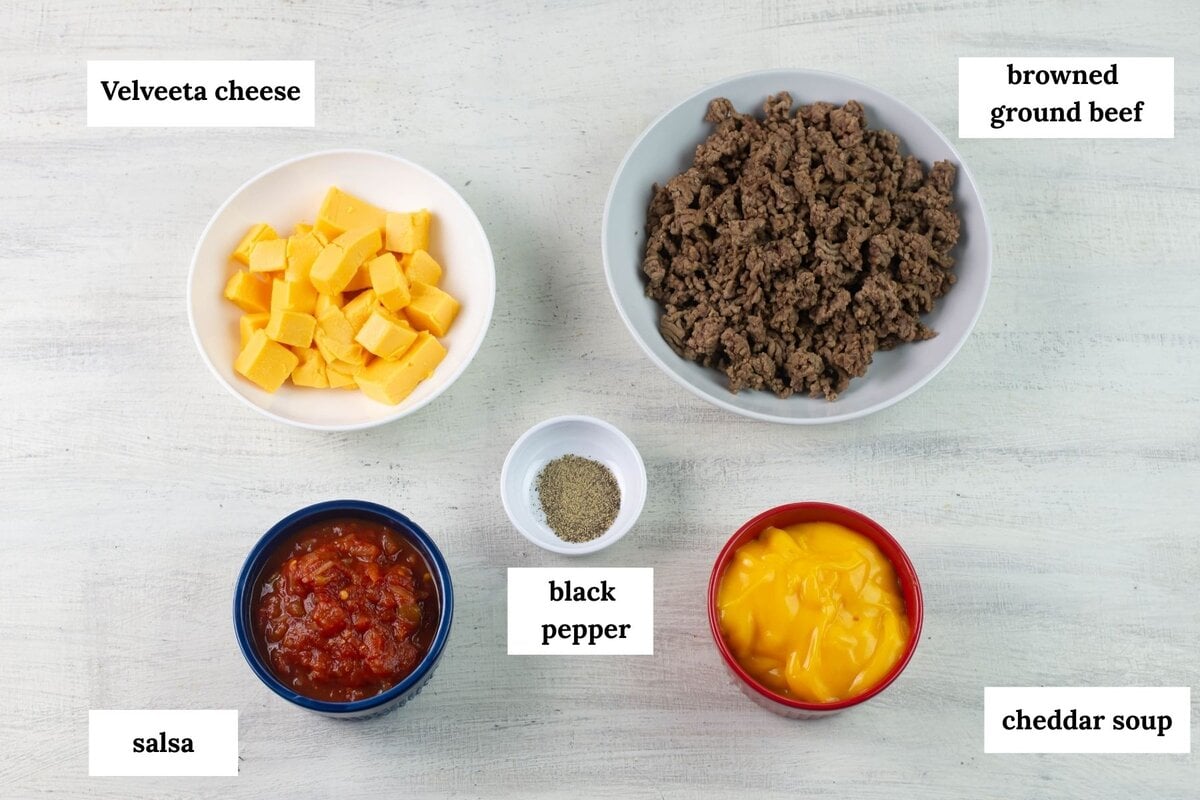 5 ingredients from ground beef and cheese dip measured into bowls.