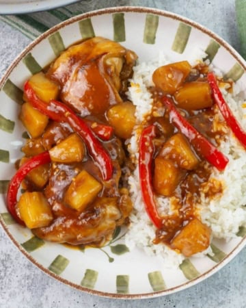 Hawaiian bbq chicken with pineapple served over rice in a bowl.