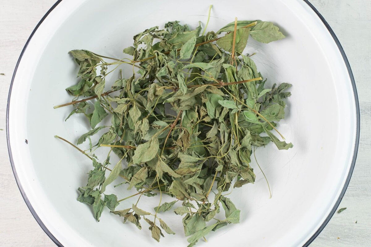 Dried herbs in a large enamel bowl.