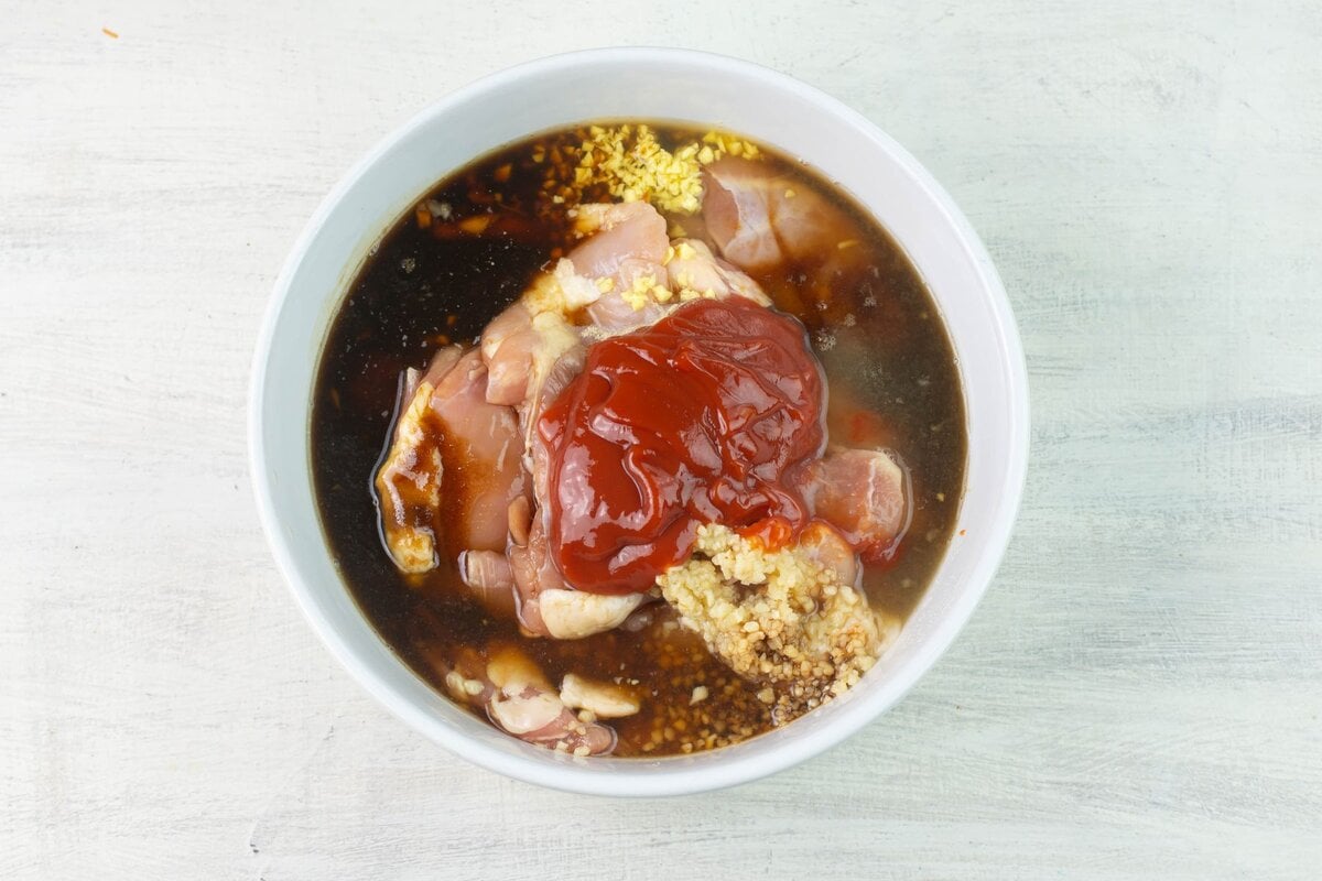 Chicken thighs on a bowl with marinade.
