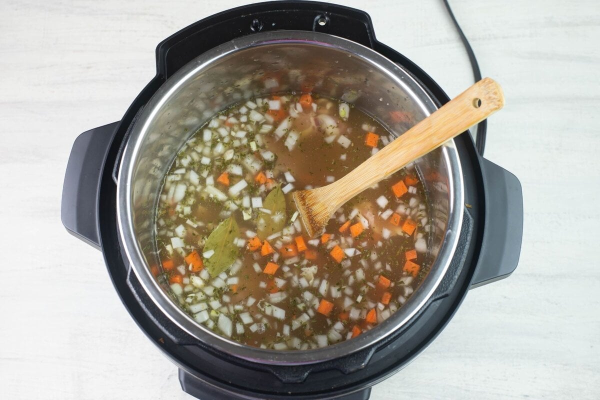 Ingredients covered in chicken broth.