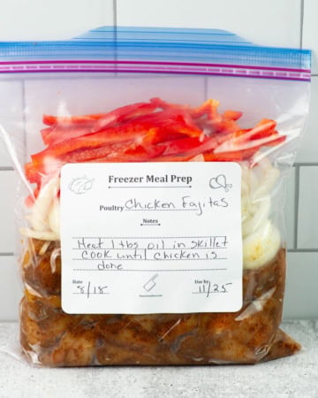 A quart freezer bag filled with ingredients to make chicken fajitas.