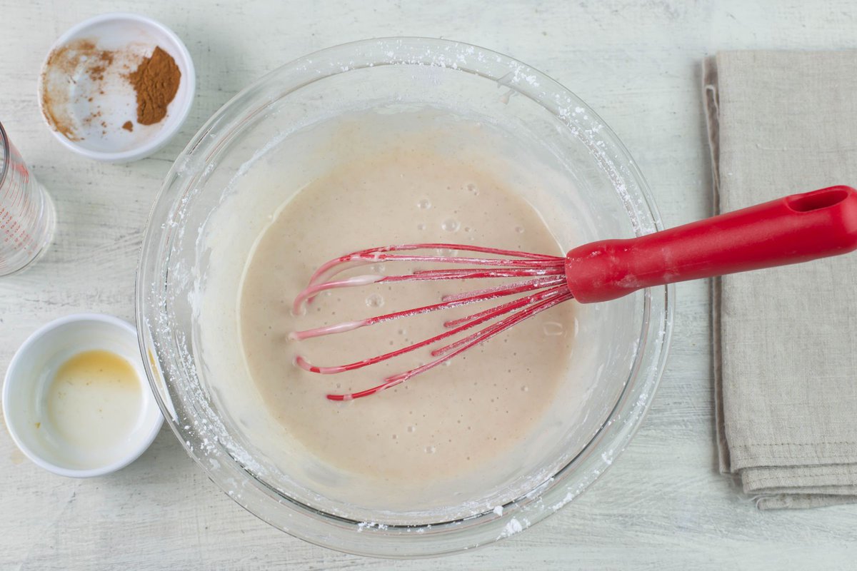 With bowl with powdered sugar icing.