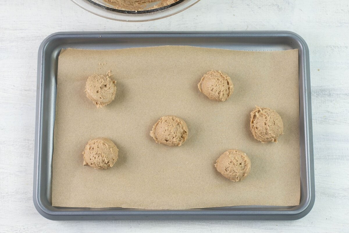 Cookie dough on a cookie sheet before baking.