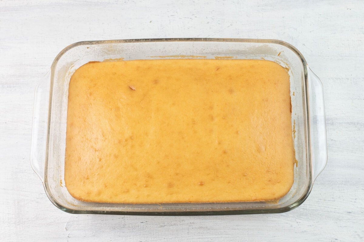 Baked white cake in a 9x13 glass pan.