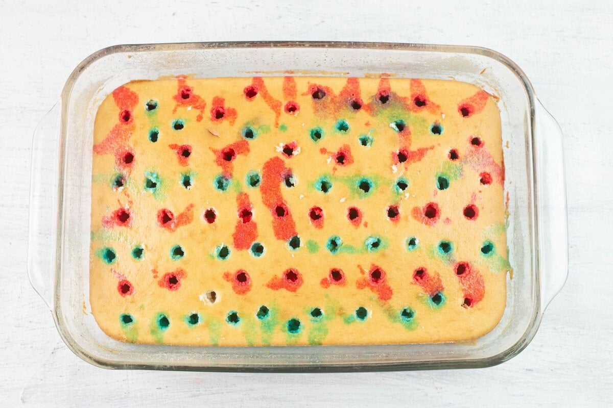 9x13 white cake, poked with holes, and filled with red and blue JELL-O.
