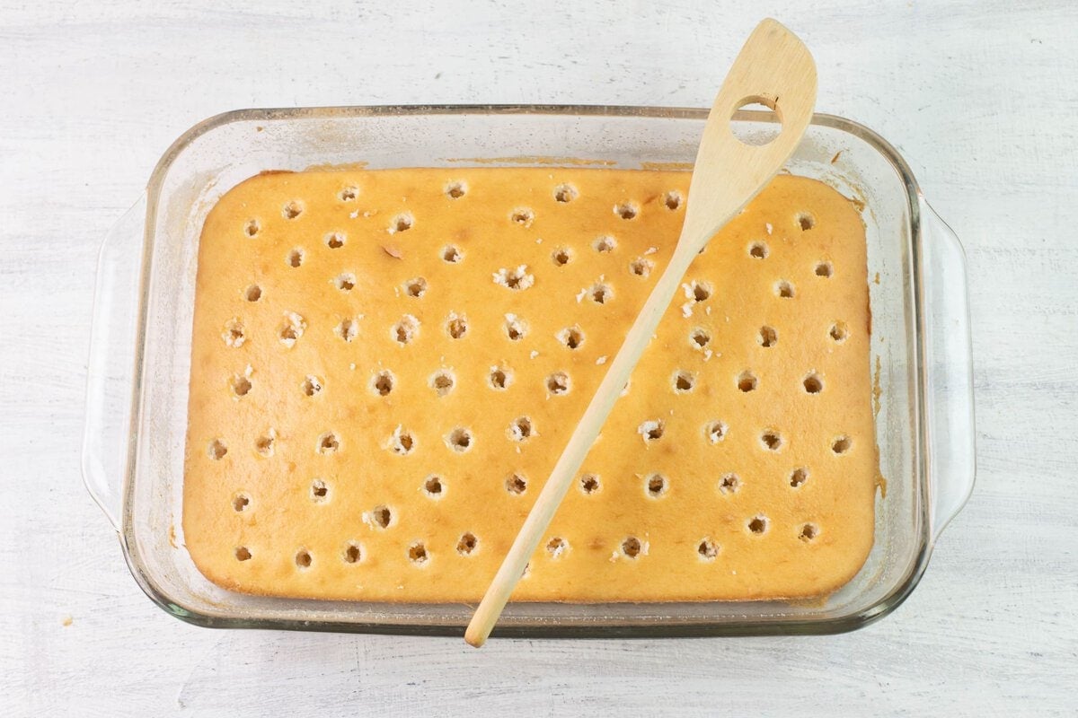 White cake with poke holes for JELL-O.