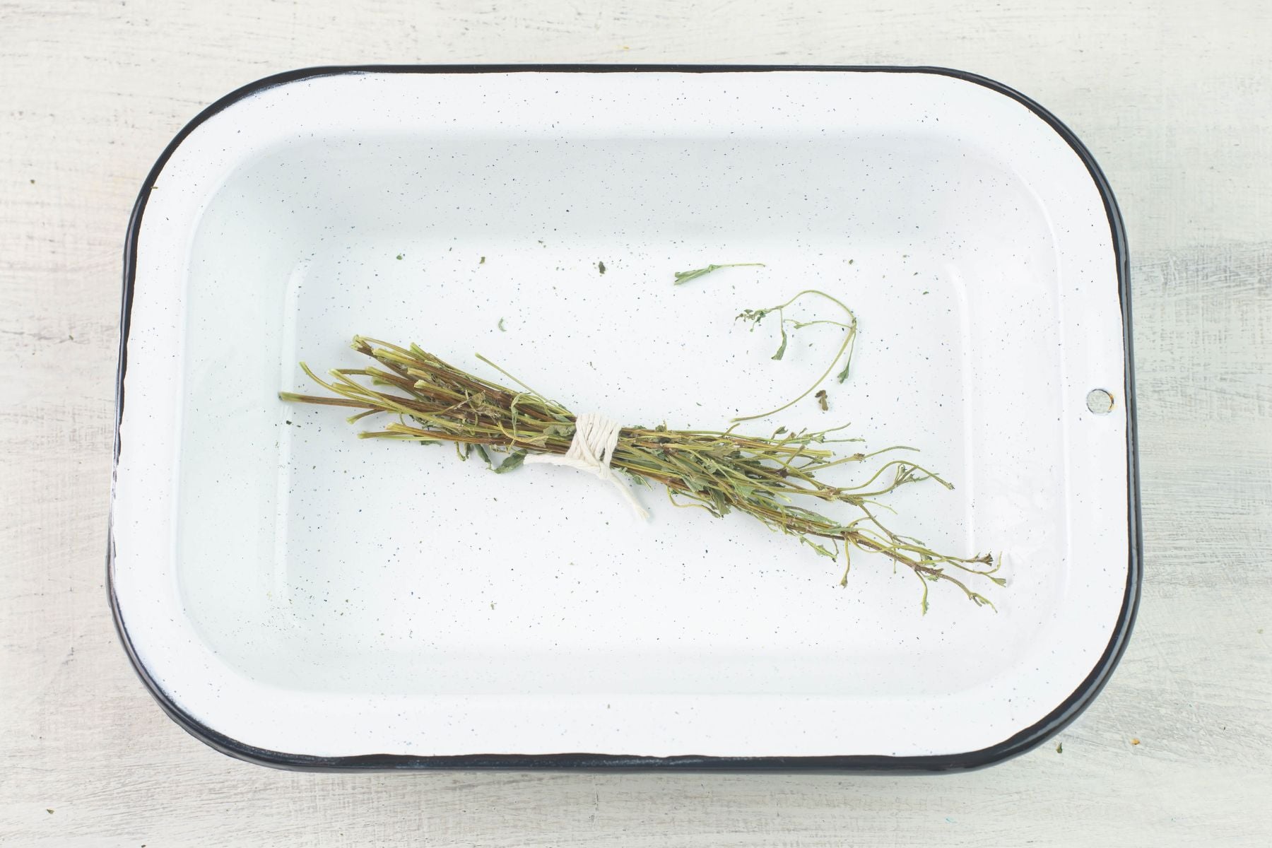 Herb fire bundle in a granite bowl.