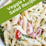 Closeup of a bowl of asparagus tomato pasta salad.