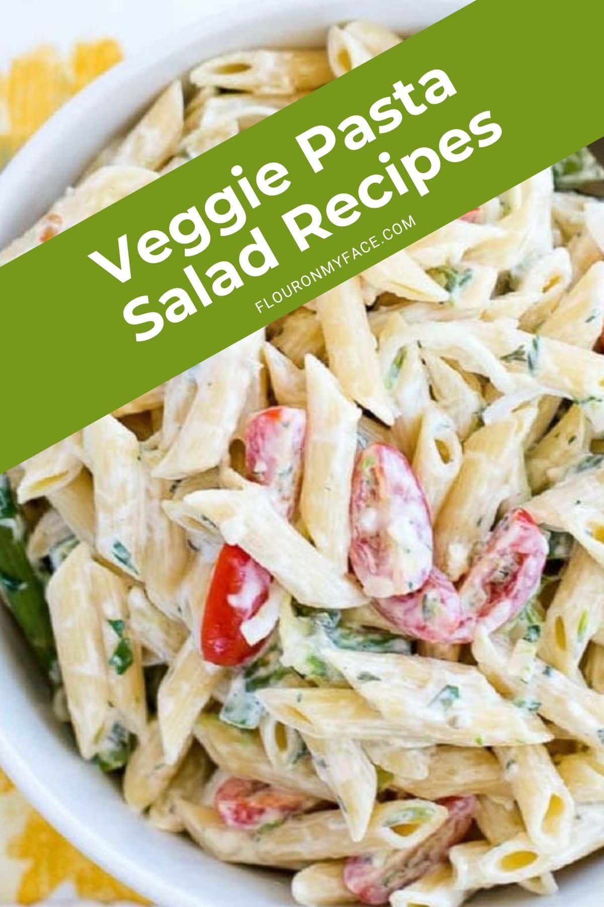 Closeup of a bowl of asparagus tomato pasta salad.