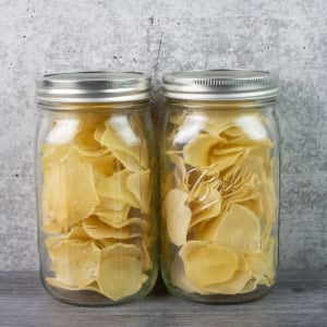 Two quart mason jars filled with dehydrated scalloped potatoes.