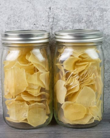 Two quart mason jars filled with dehydrated scalloped potatoes.