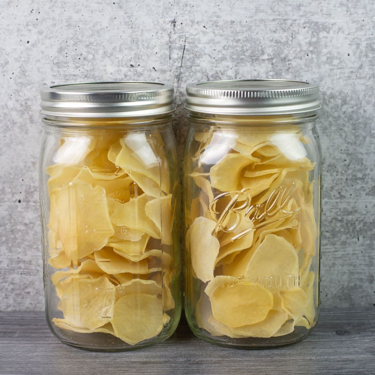 Two quart mason jars filled with dehydrated scalloped potatoes.