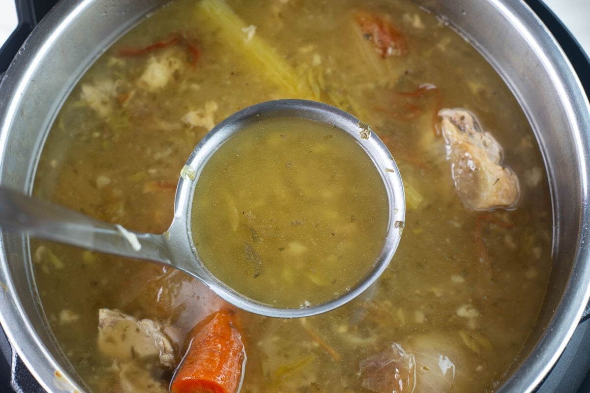 Overhead photo ladle full of broth.