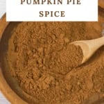 Vertical image of wooden bowl filled with pumpkin pie spice.