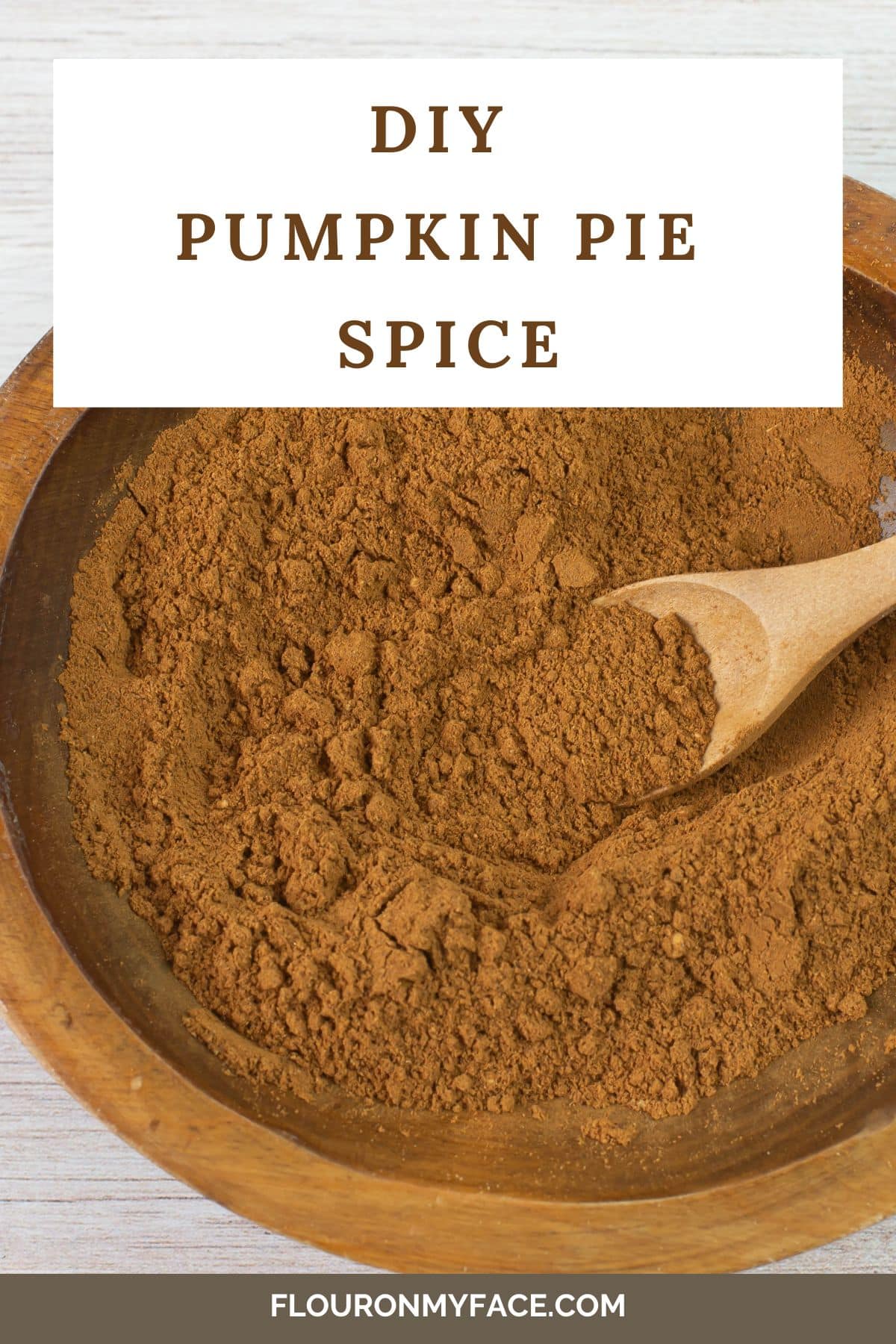 Vertical image of wooden bowl filled with pumpkin pie spice.